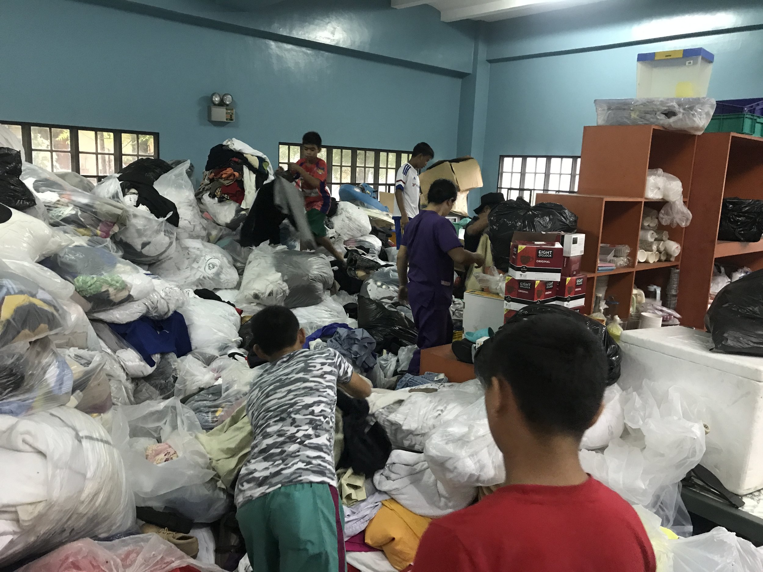 Tuloy kids help in sorting out donations.