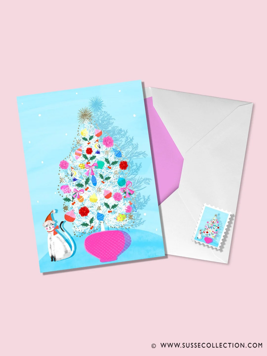 A photograph of a colourful illustration of a cat and mid century Christmas Tree as a greeting card