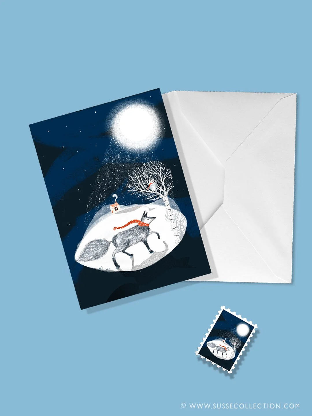A photograph of an illustration of a wolf and winter scene on a greeting card