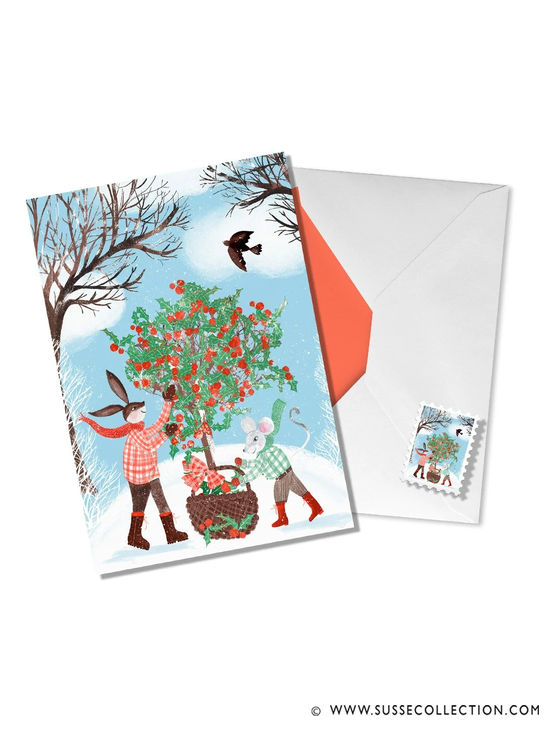 A photograph of an illustration fo a rabbit and mouse gathering holly in a winter snow scene. on a greeting card