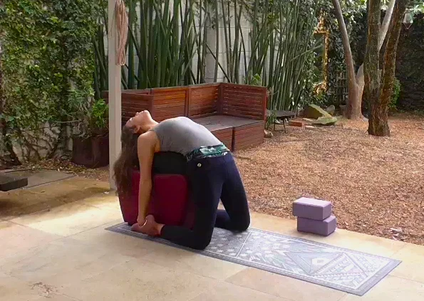 Supported camel pose. Use an ottoman or low table with cushions on top. make sure to have an extra cushion for under the head. Push your hips forward. Hold for 10 breaths.