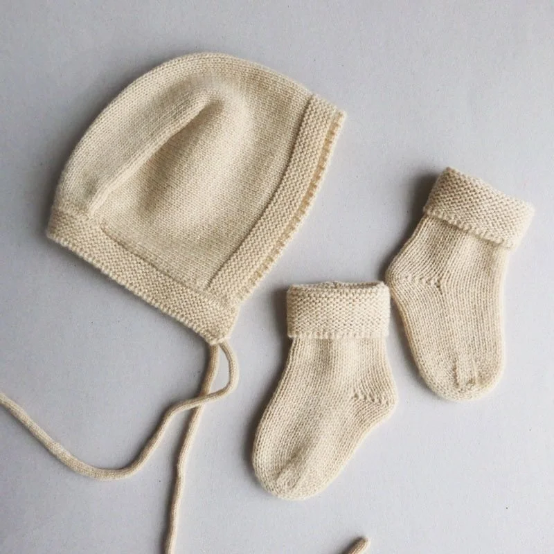 Our beautiful Merino bonnets and socks comes in a set or separate. Works well over 6m too since the wool stretches so nicely. Super soft and cozy for spring. #betonstudios