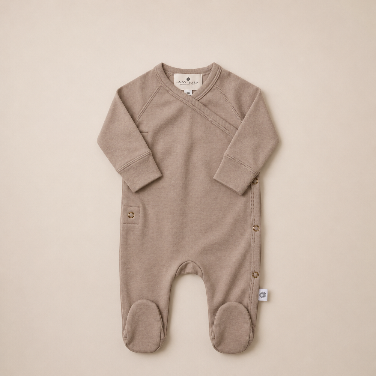Minimalist beige babyromper med fotdel.png