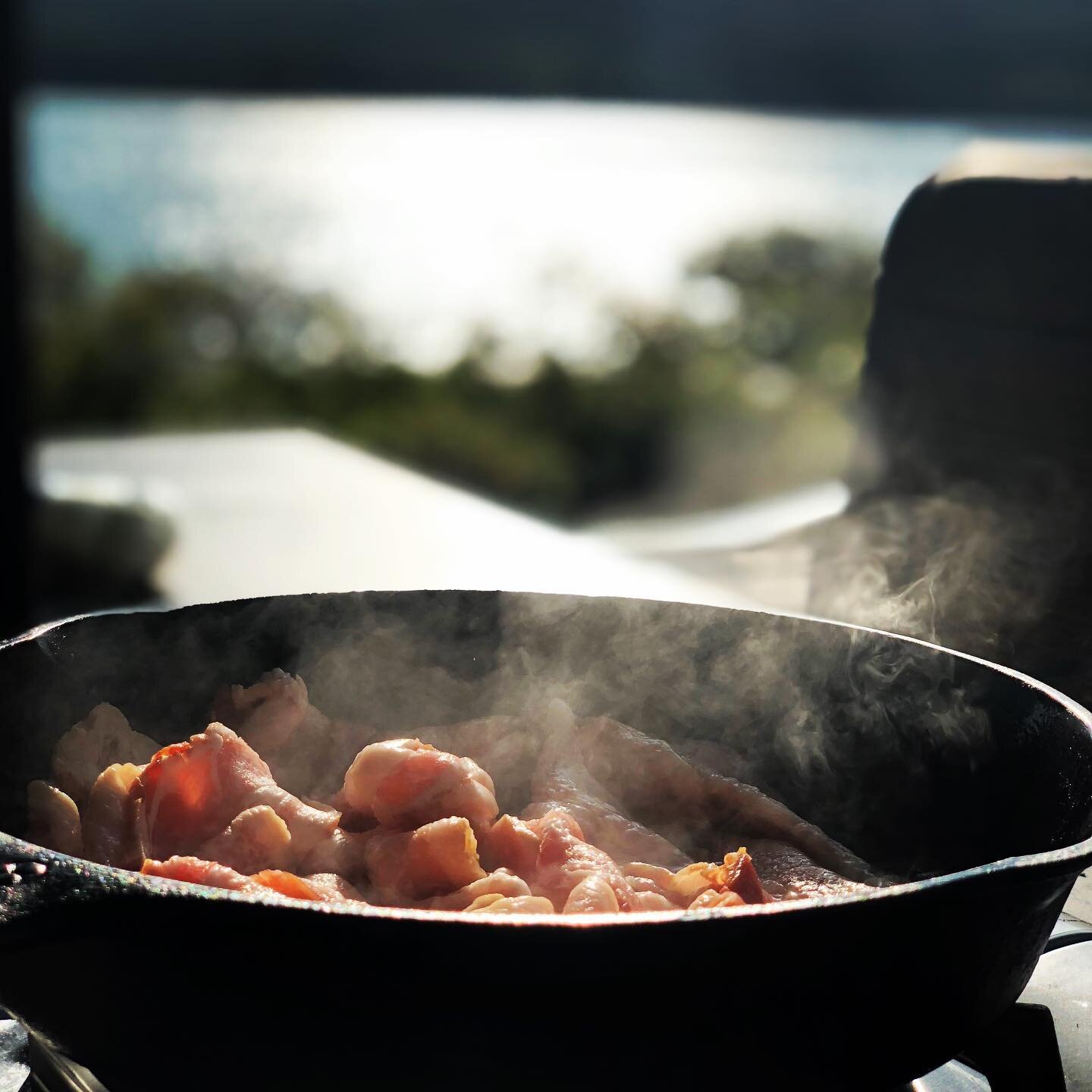 Cooking bacon on Sommes Sound overlooking Acadia National Park, Maine.