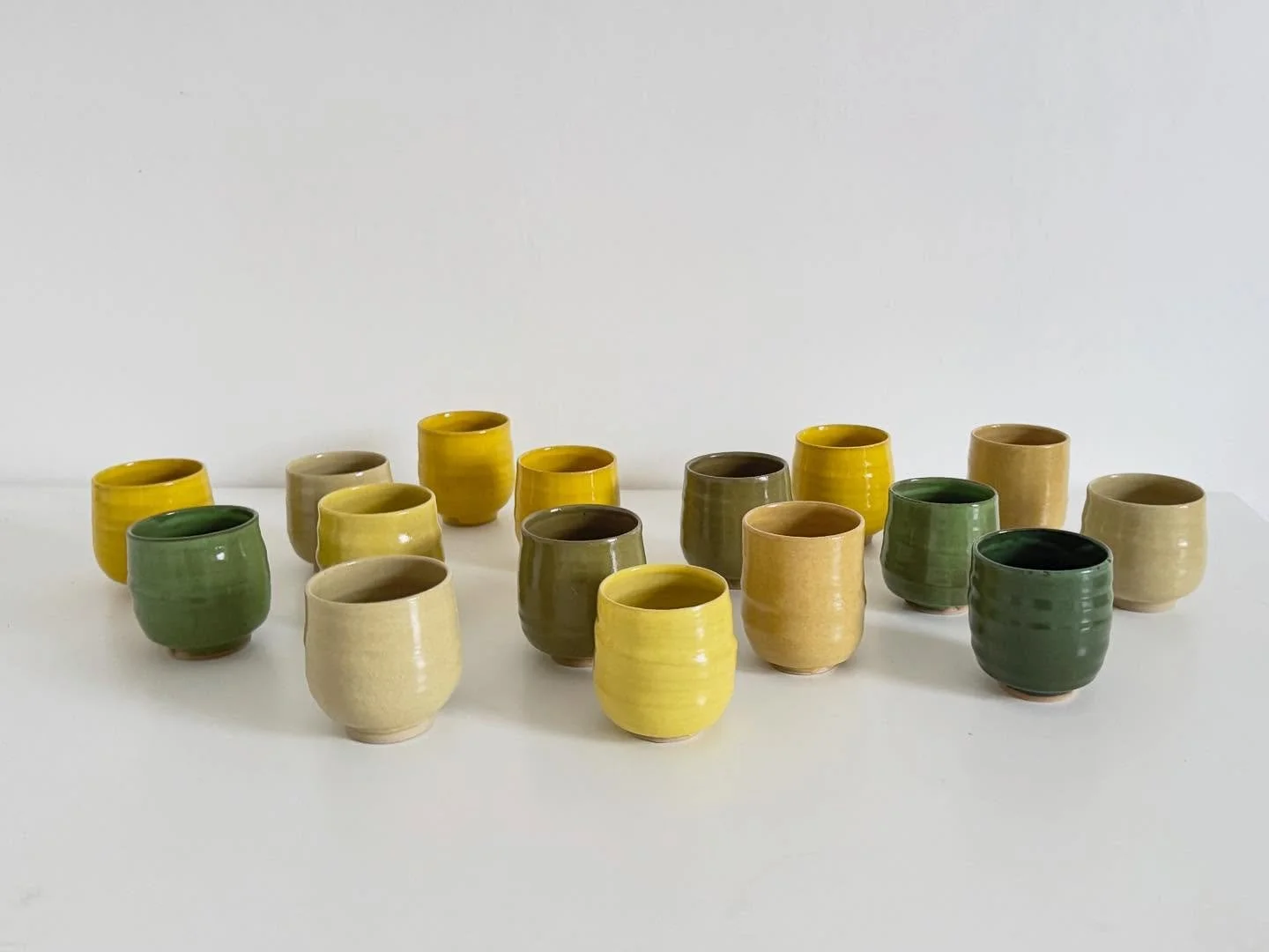 Tea bowls and coffee cups in many colours from my recent electric firing, all going off to @theleachpottery and @newlynexchange this week; thank you so much Mark and Fran! The last photo is the next batch drying on top of Guy&rsquo;s printing press w