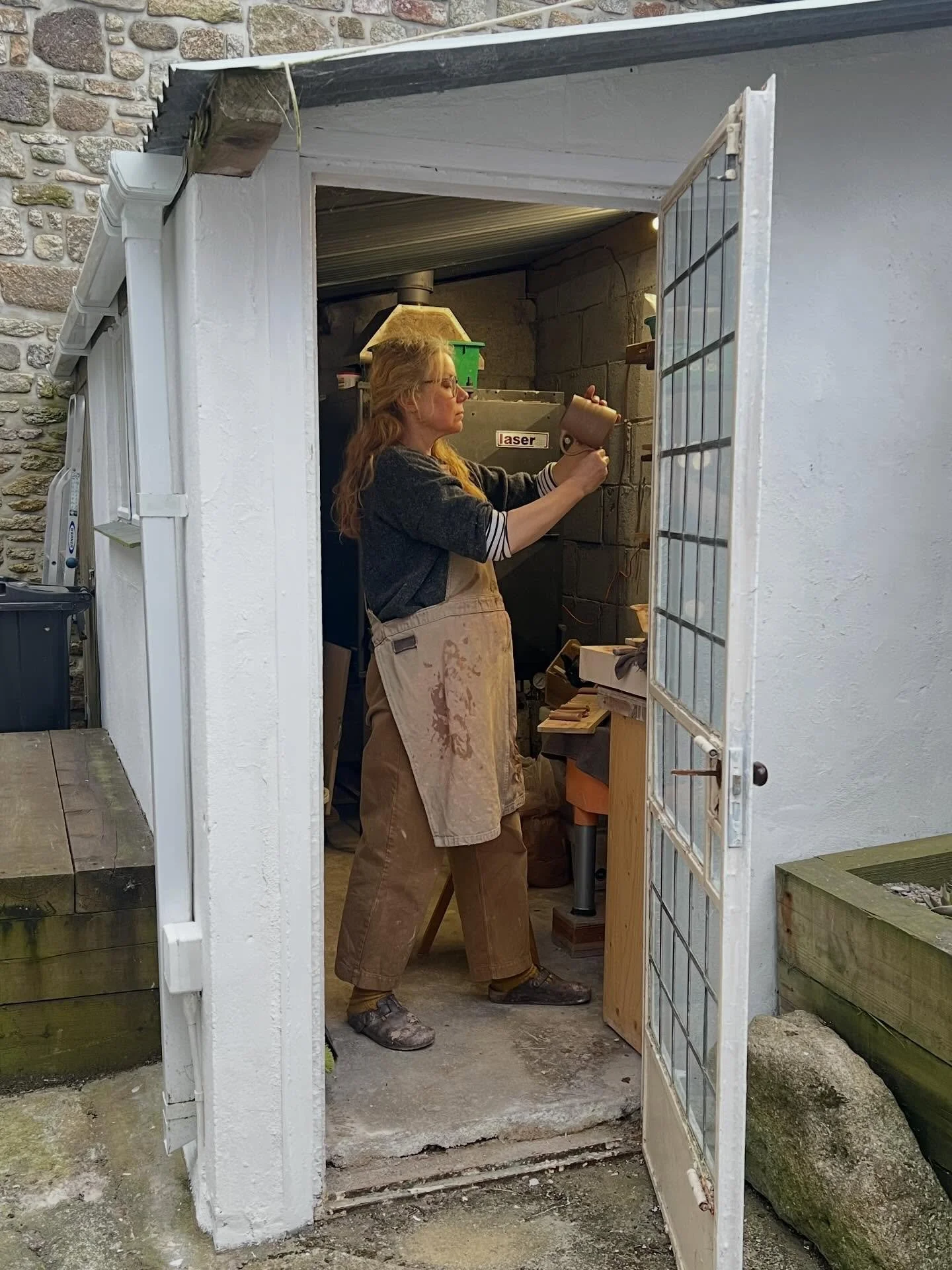 This evening I&rsquo;ve been working in the shed, which has been newly painted by @guyrutterpaint 🙌 putting handles on a few mugs in the dusk. They&rsquo;ll dry nicely indoors on the shelf and will be reduction fired in the gas kiln, probably with a