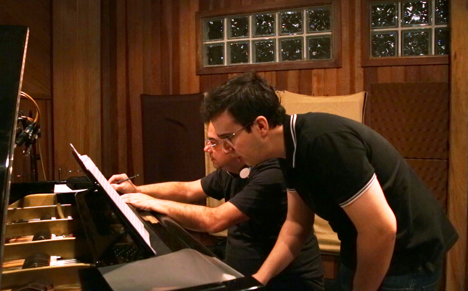 Paulo Braga and Rafael Piccolotto de Lima reviewing parts.