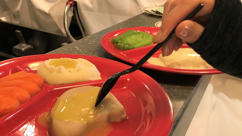 Students sample foods from our Textured Modified Dining Program. This program provides great tasting and nutritious pureed meals for residents with oral health issues and swallowing difficulties. Red plates enhance the color and appearance of food. This divided “adaptive plate” helps some memory care residents get their food onto their fork.