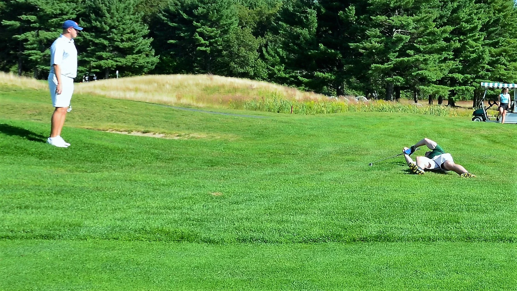 Director of Financial Operations Dennis Murphy mourns a missed shot while Finance Manager Pat Mathews looks on.