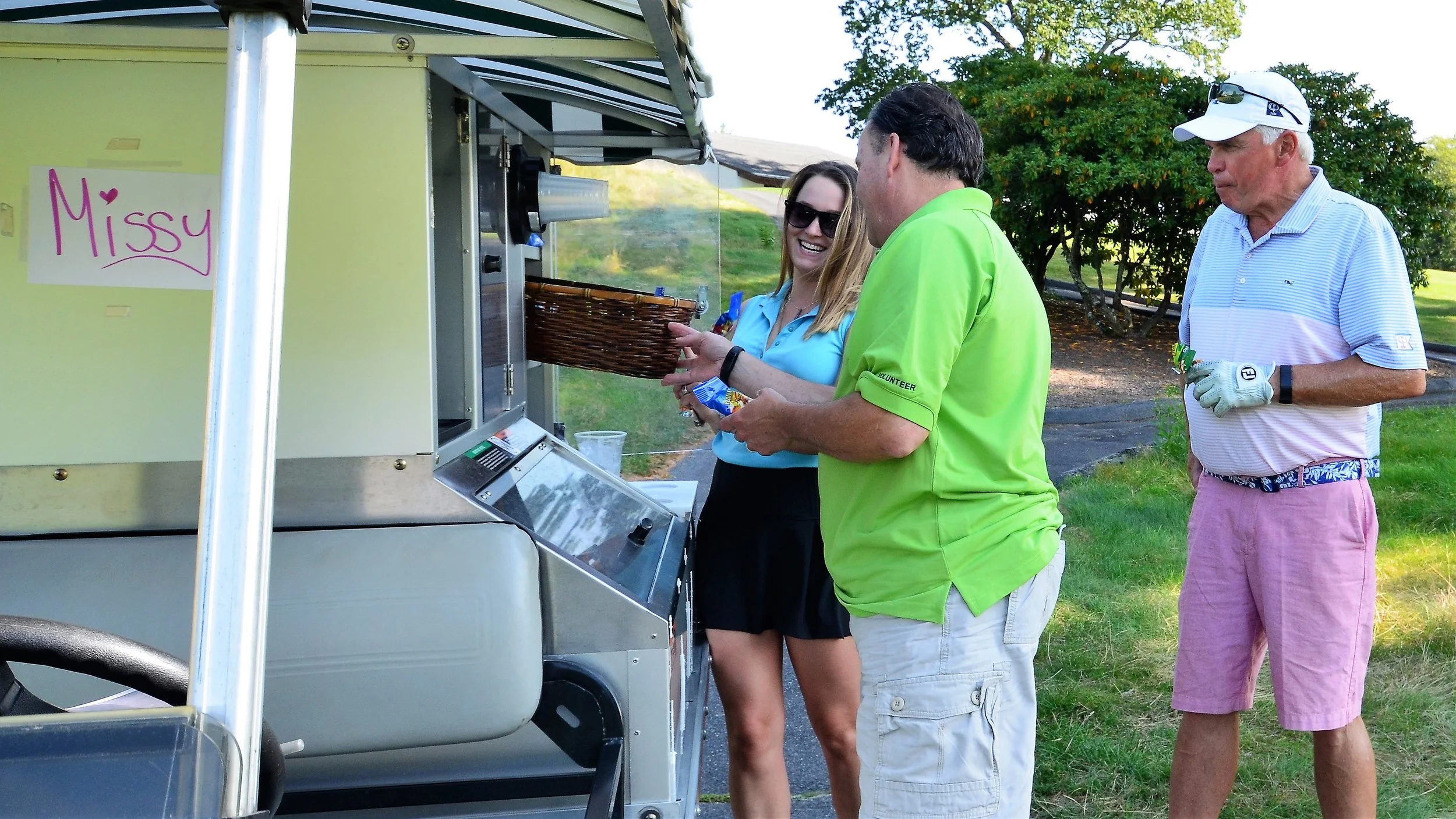 Vice President of Dining and Facilities Guy Hemond and David Donnelly of Gordon Food Service at the food and beverage cart.