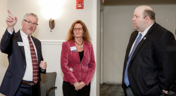 Mike Myers, regional director of sales and marketing for Benchmark Senior Living, and Susan Cwieka, campus executive director, point out key renovations to Sen. Feeney