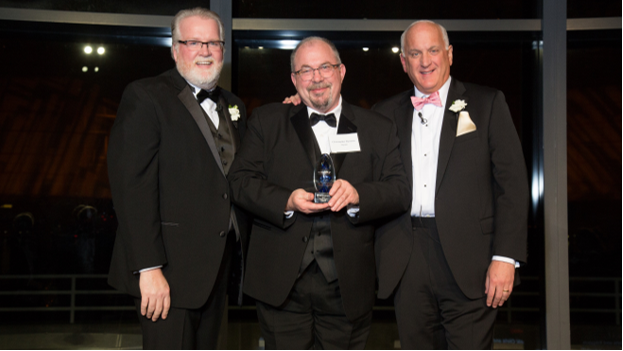 Edgehill Executive Director Chris Barstein , center, accepts the Ripple Award from Bob Moran and Tom.