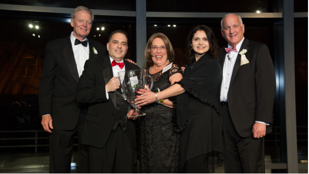Ridgefield Crossings Executive Director Bill Crawford , second from left, Front Desk Receptionist Patricia Andrews , center, and Senior Director of Business Administration Tami Beck accept the Peter M. Small Award for Community Excellence for their community from board member Peter Small , far left, and Tom.