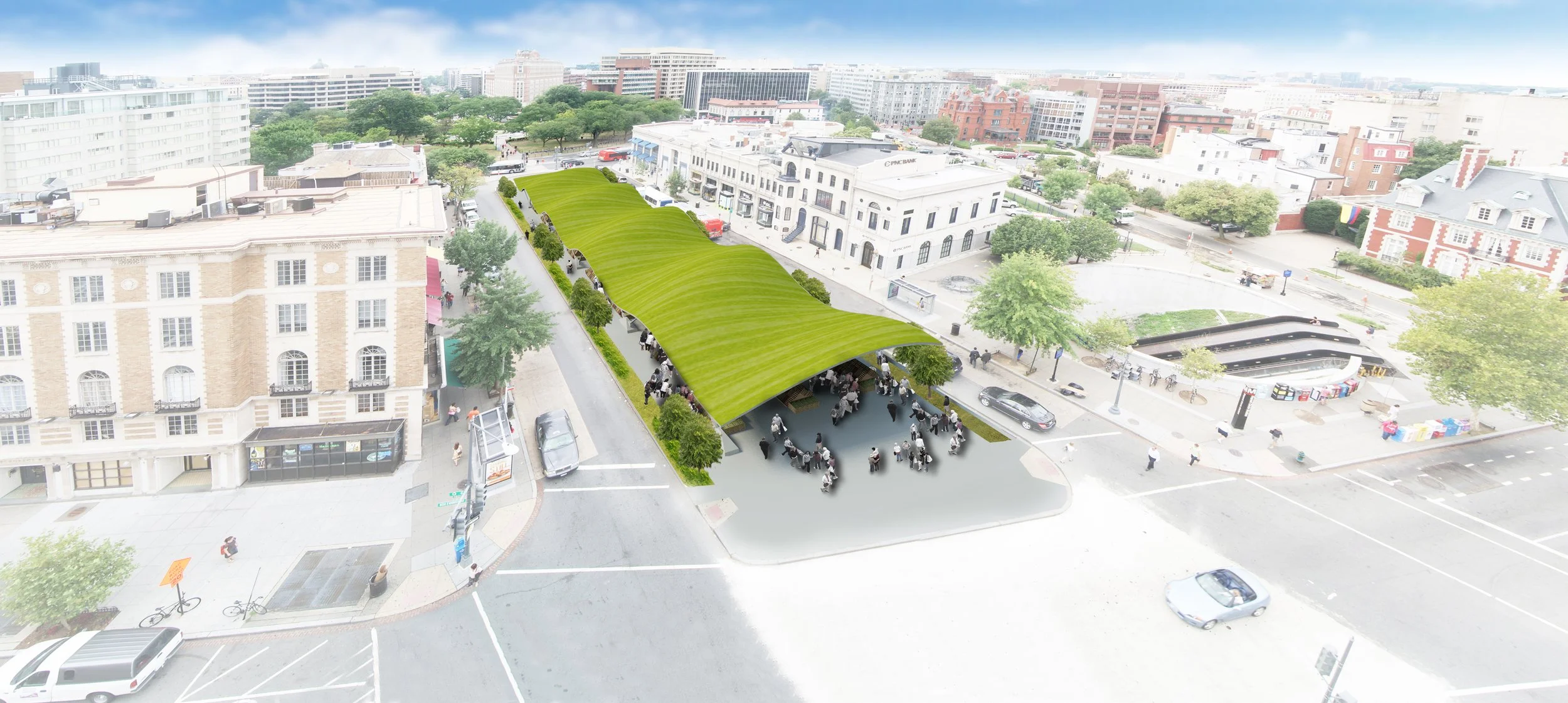 An aerial view of a city square with a modern, curved, green roof structure covering a public gathering area, surrounded by trees, buildings, and cars.