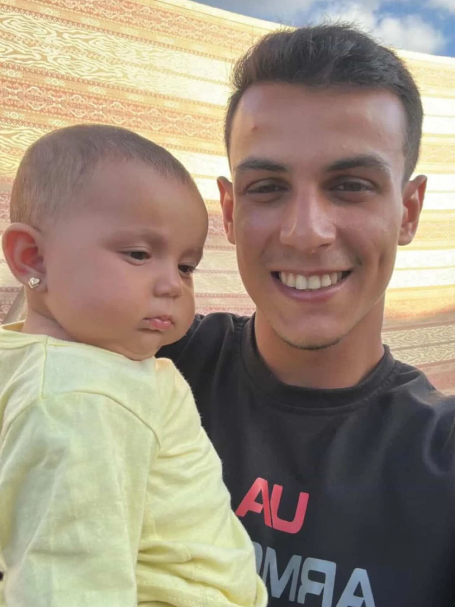 Instead of a comic today, I’d like to share this photo of my friend @hesham.majed β€οΈ Hesham lives in Northern Gaza and is the most amazing human. This is him with his niece, Eman, who was born in April. You can donate to directly help this fami