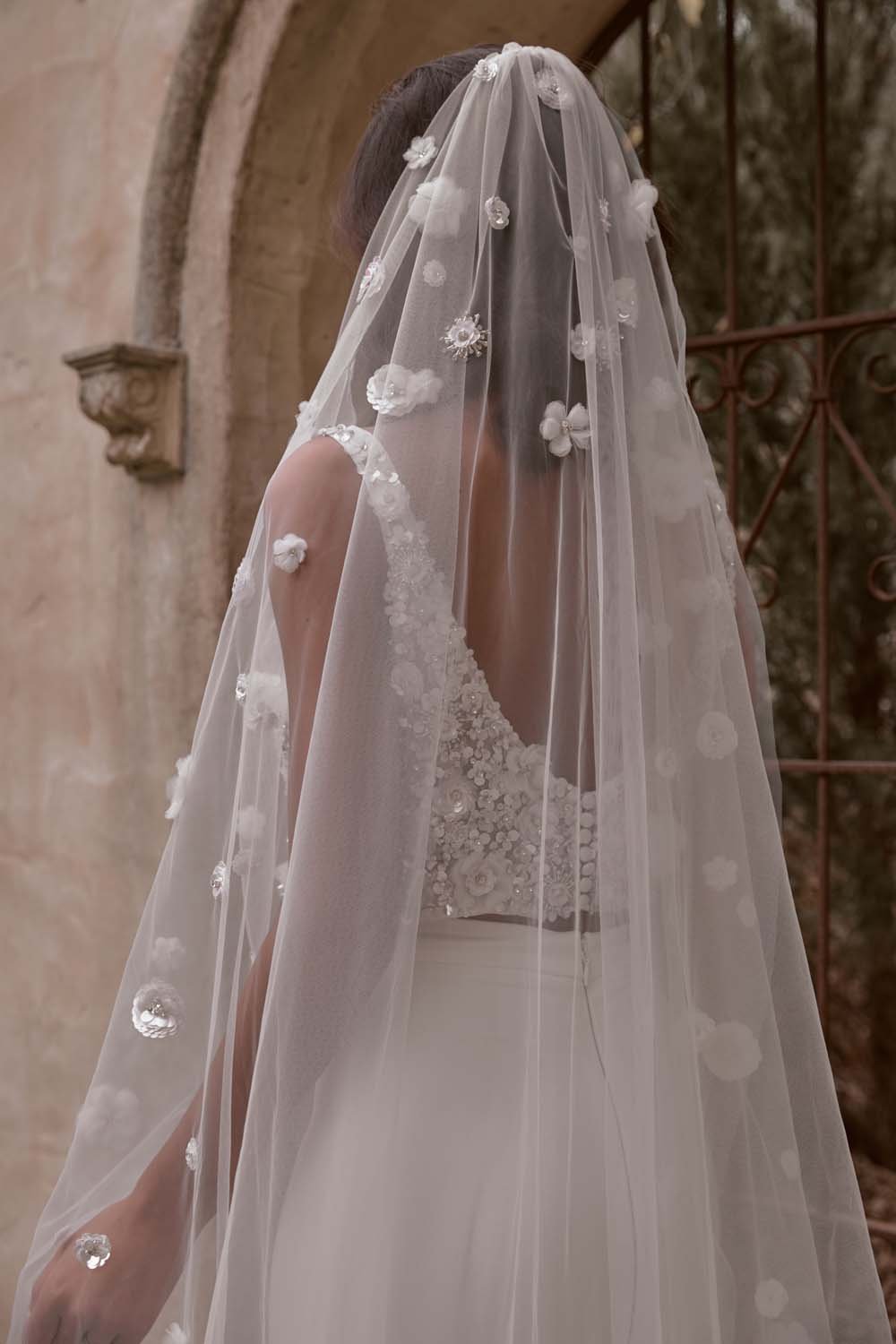 Enhance your bridal elegance with the Ginger Veil, captured in a stunning chateau setting. Featuring 3D floral embellishments and a flowing design, it adds a touch of romance and luxury.