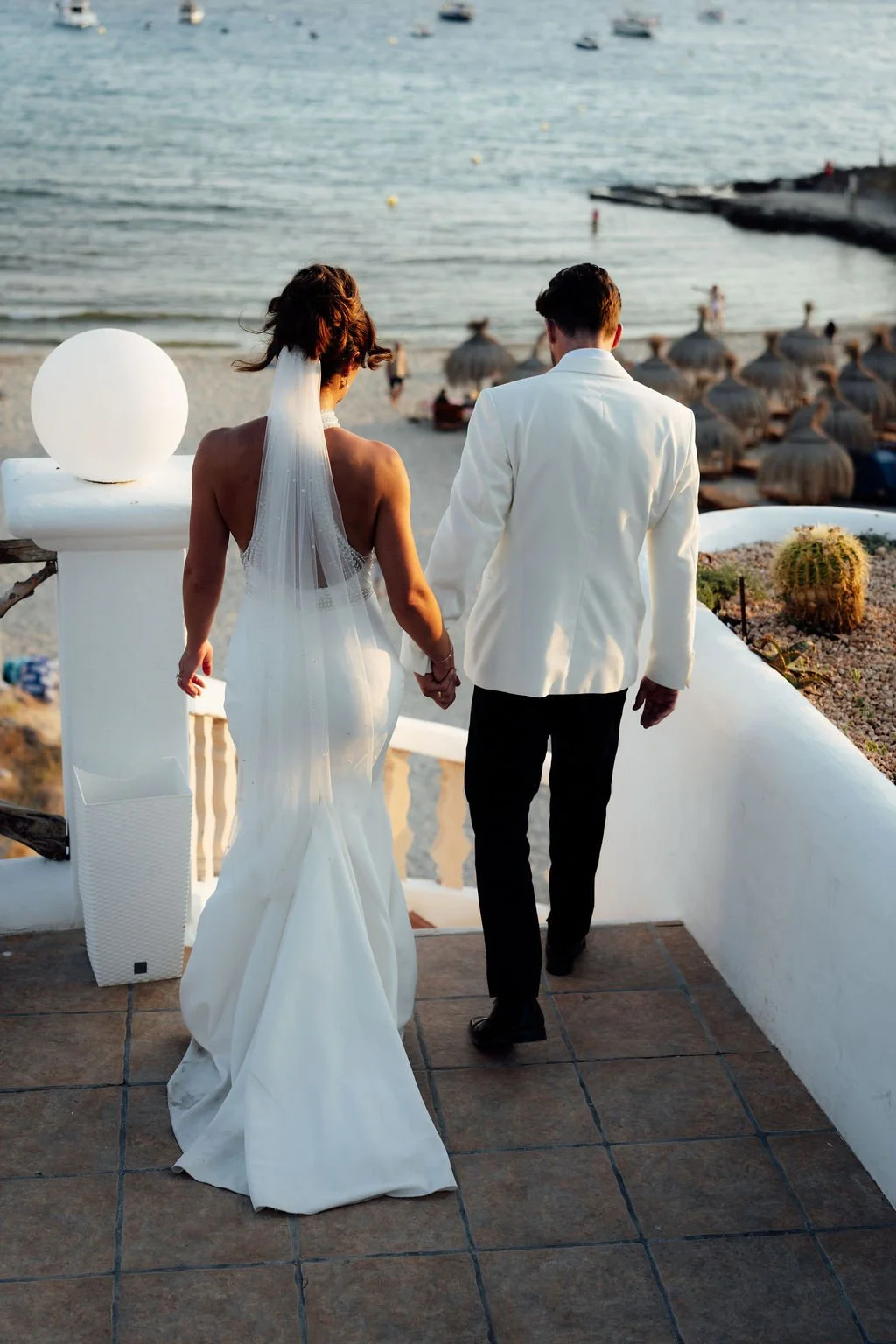 Detail of Anna Campbell Cameron gown with linear hand embellishment at Ibiza wedding. Feature backless dress paired with lightly pearl veil