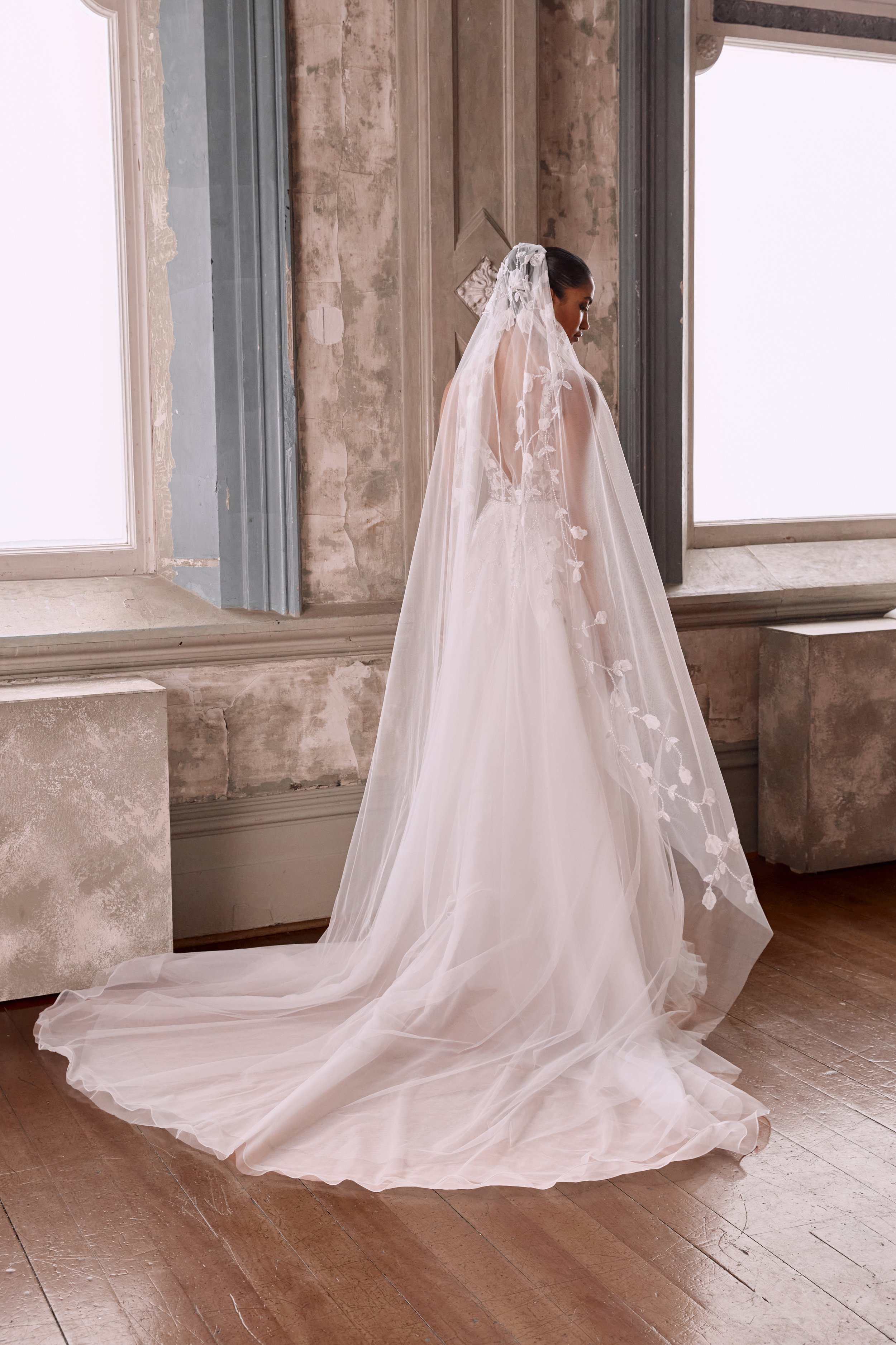 The Iris Veil steals the show in our BTS look at NYC Bridal Fashion Week. Adorned with elegant lace and beading, it’s the perfect blend of grace and glamour for your big day.