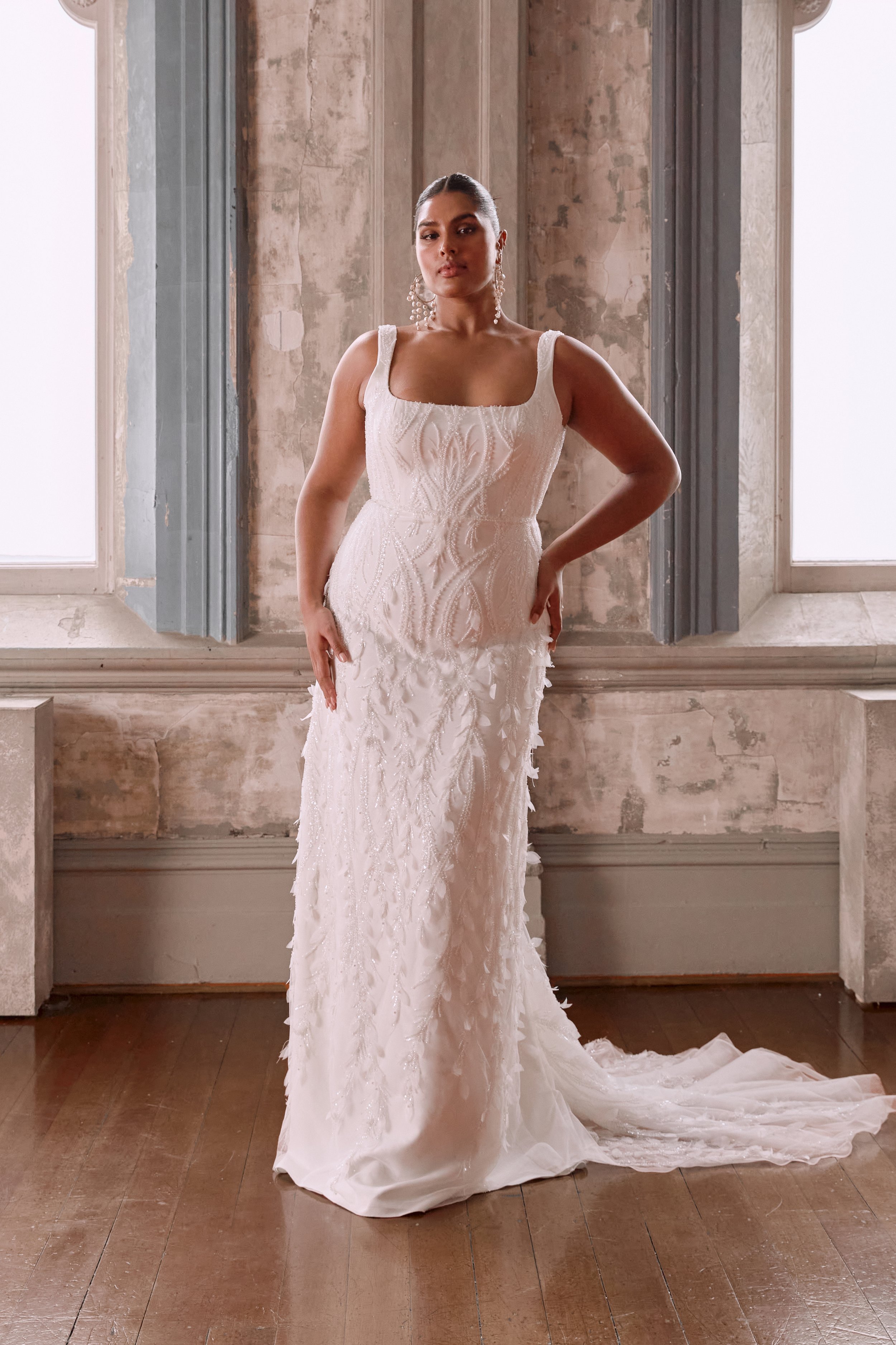 Embrace elegance with the Winslow gown, featuring subtle sparkle and unique feather-like details.