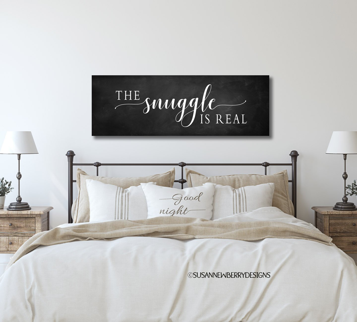The snuggle Dark Chalkboard canvas hung over bed