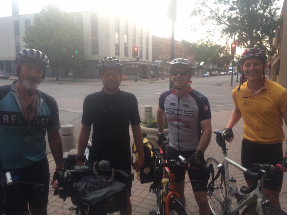 Hans and Mike standing with two other bicyclists in the morning fog