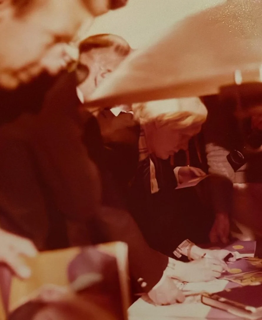 Andy Warhol signing his work