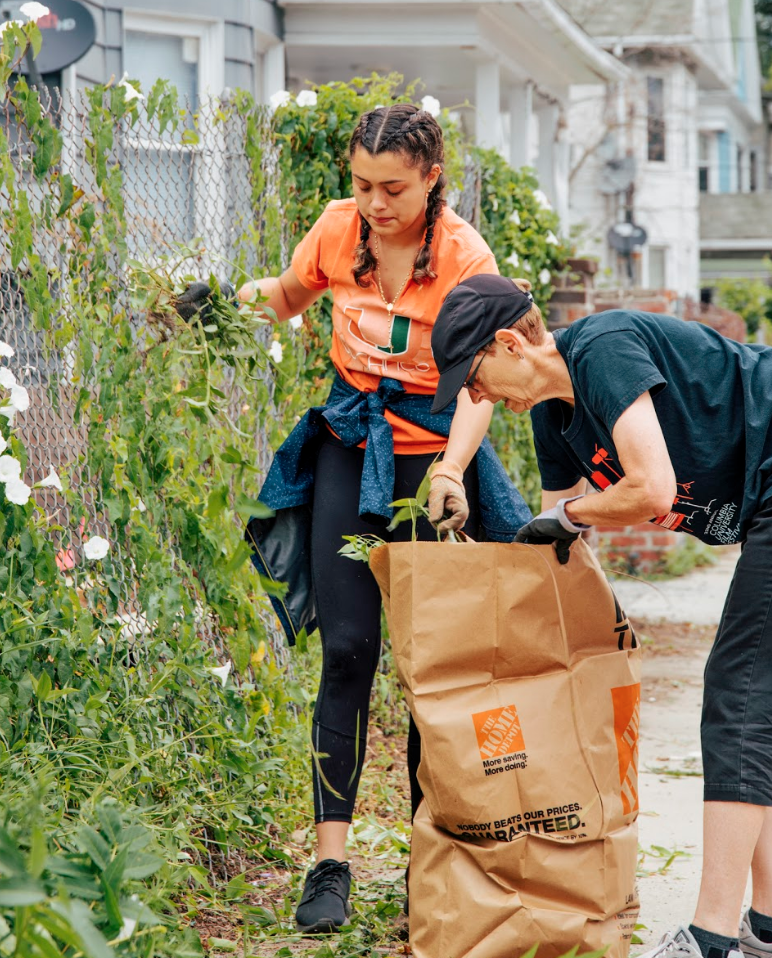 Kelly and Penny help to clean up the Arctic St. community garden!