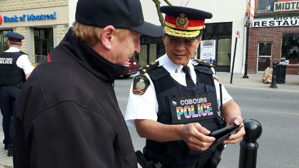 Cobourg Police Chief Kai Liu in the rainbow-stitched vest officers will wear throughout June