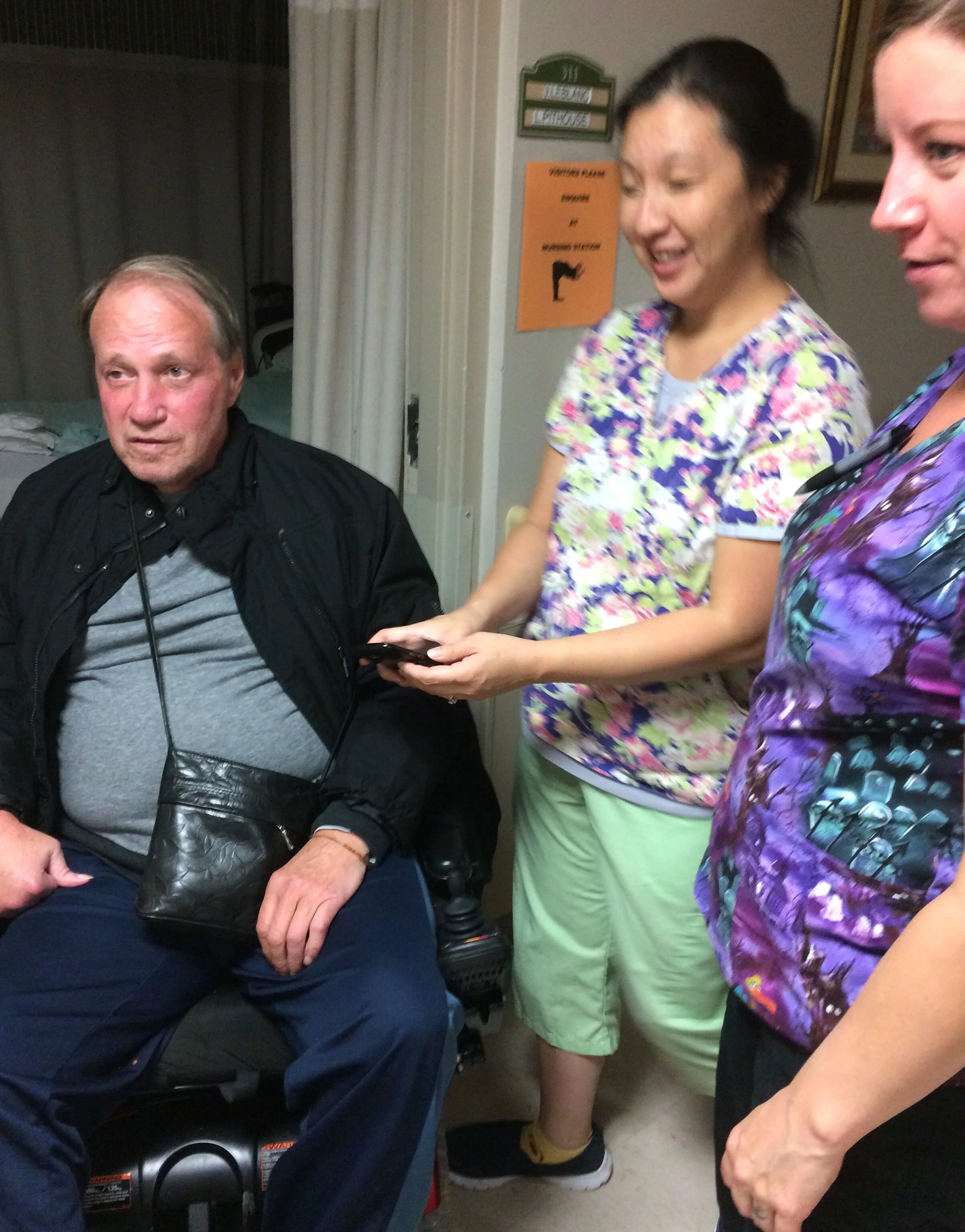My dad shown getting ready to head out on a Friday night (pre-pandemic) with two of his friendly support workers who make all the difference in the world to us.