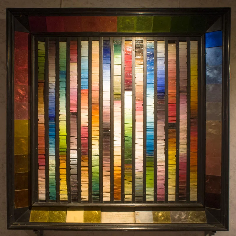 The multicoloured panel, created as a sample collection of smalti and gold mosaic tiles.