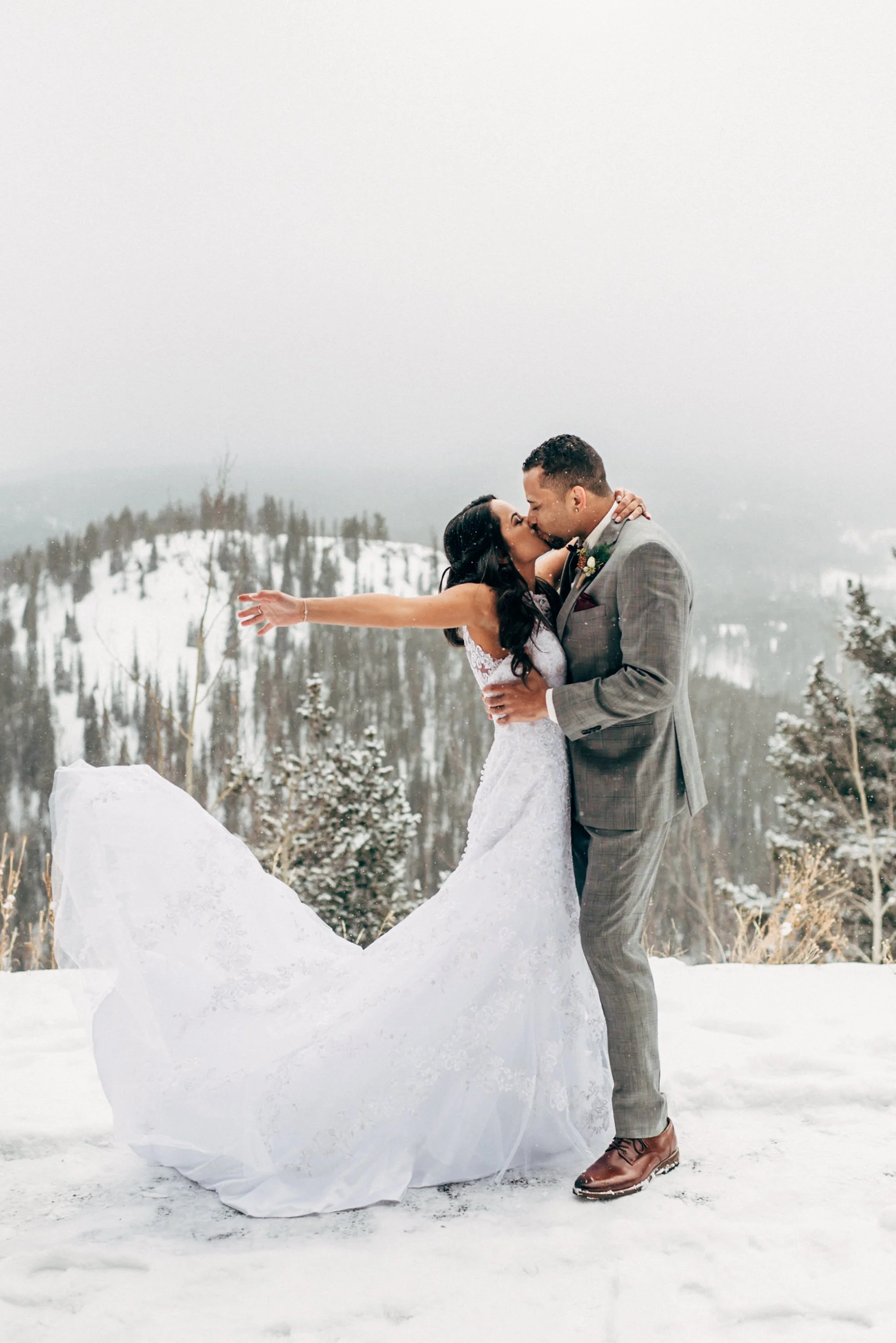 Dancing and celebrating in the snow at their Breckenridge wedding. Colorado Wedding Photographer.