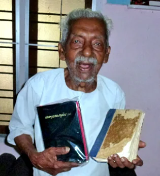 At 86, George receives a new bible to replace his well-worn old one—both which he could read without glasses!