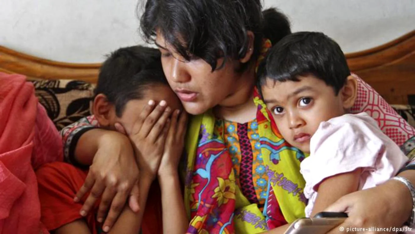 A relative consoles Ms. Khanam's children following her death
