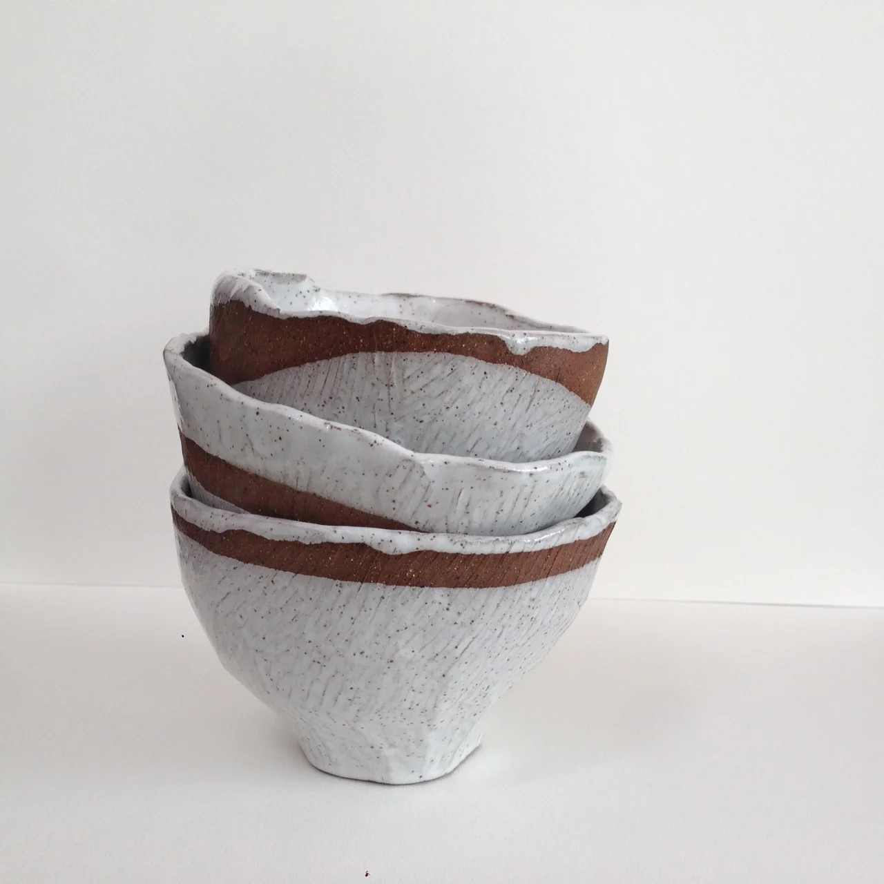  These are pinch pots that I textured on the outside using a rasp. Normally a rasp is used for coarsely shaping wood so it gives my clay the feeling of being made out of trees instead of mud. 