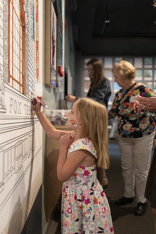  A child colors artist Rori’s illustrations on the walls of the ColoringSTL exhibit. Photo Courtesy of Missouri History Museum. 