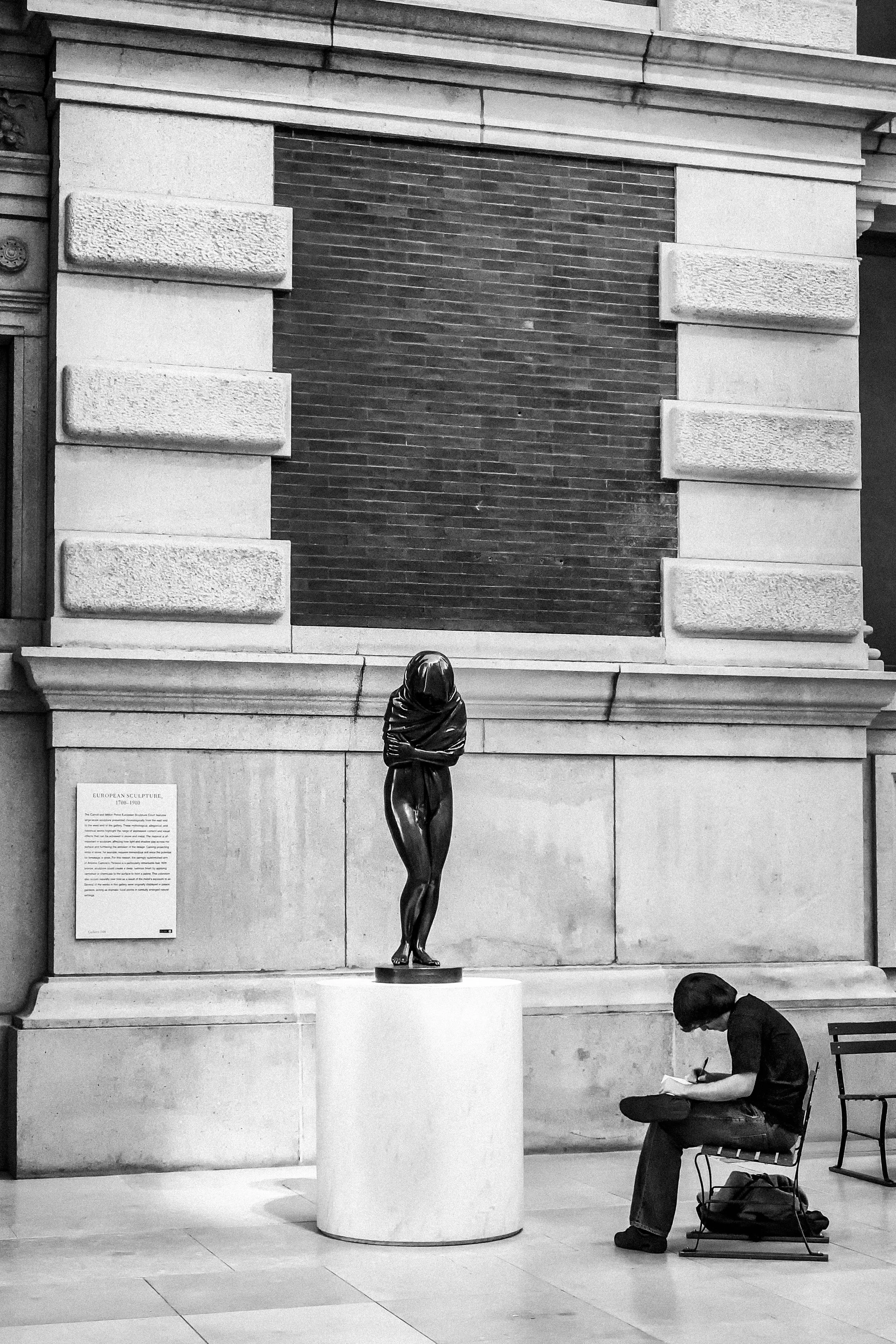 An art student sketches a statue. 