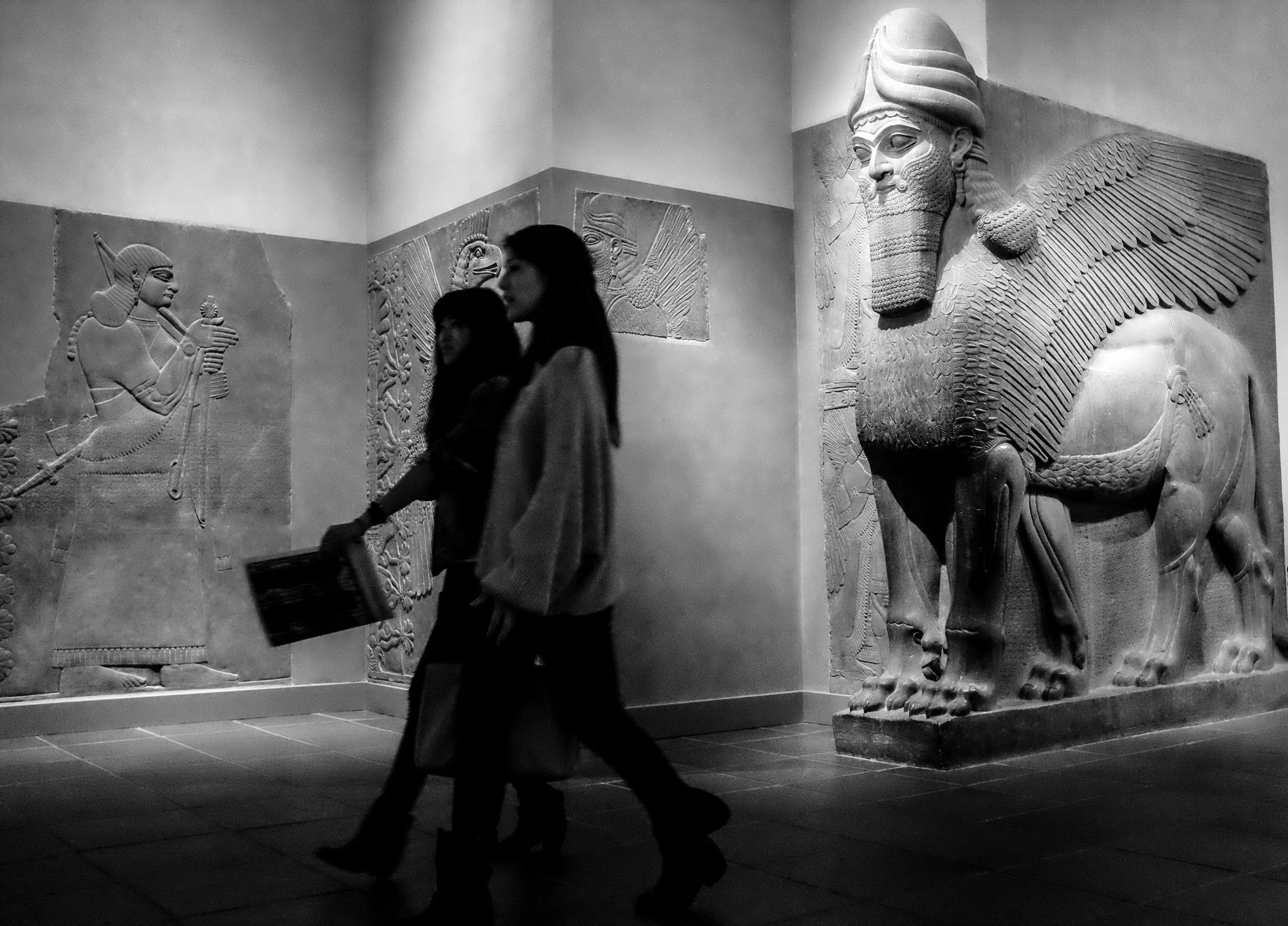  Visitors walk past an exhibit of Persian art at a Museum. 