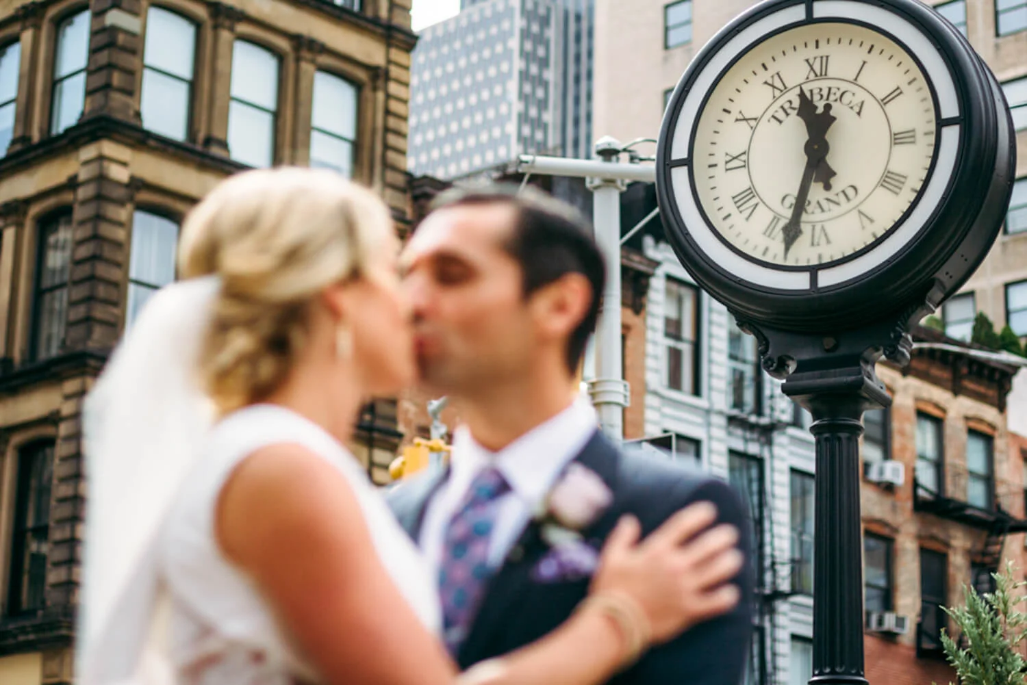kiss in front of Tribeca Grand hotel clock