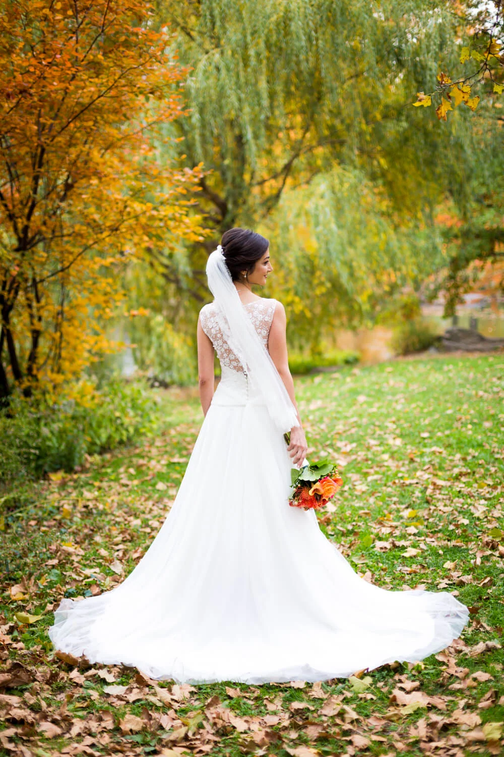 bride in Central park with colorful Autumn Fall leaves
