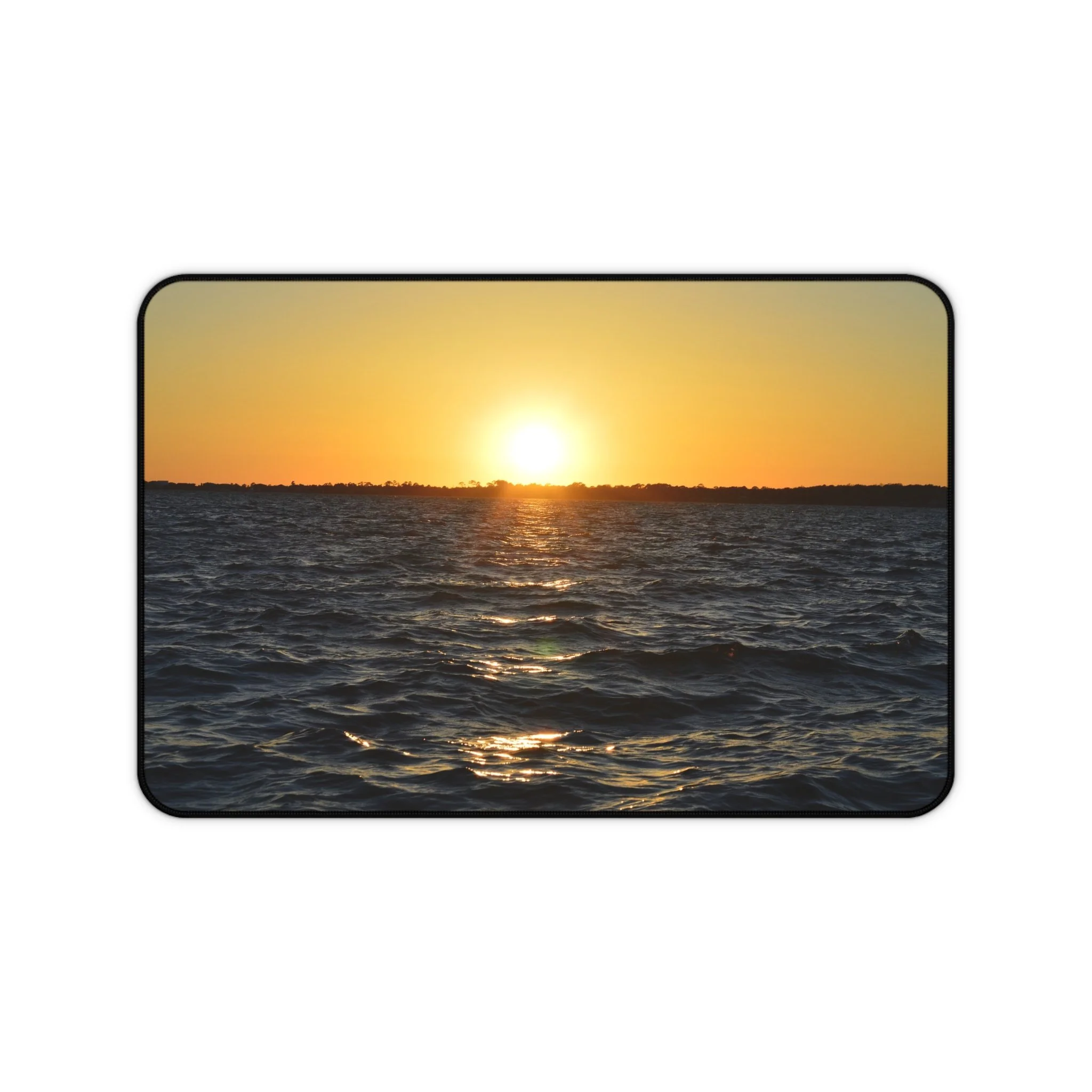 "Sunset over calm ocean waves, golden light reflecting on water — printed on a high-quality desk mat from The Abyss Collection"