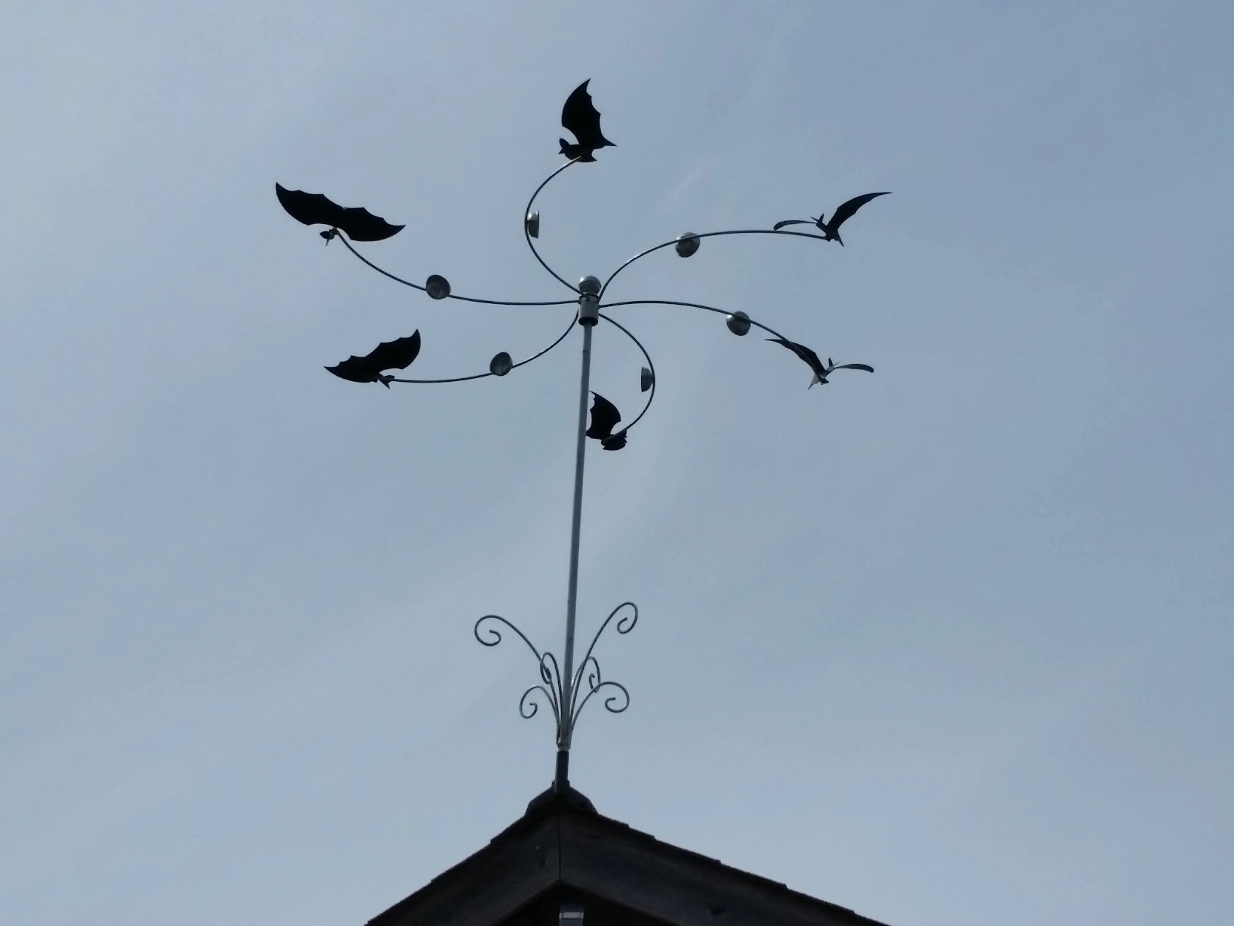 A kinetic art rooftop windmill.