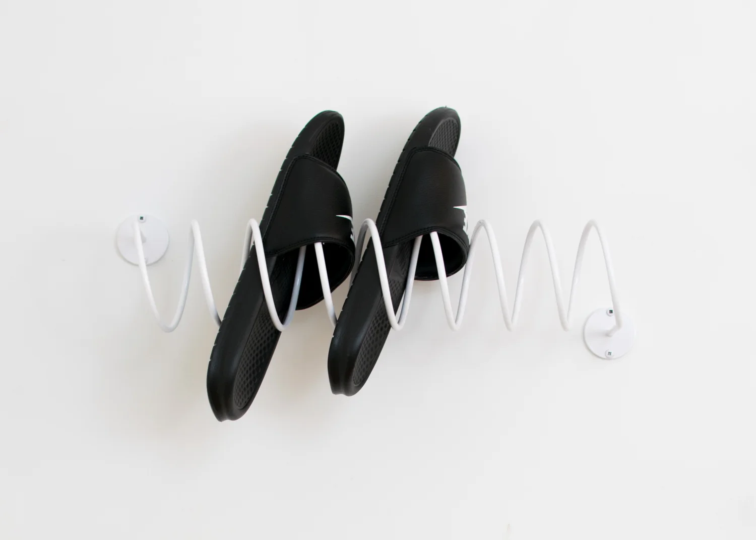 This That's Corkscrew Wall Hook holding shoes.