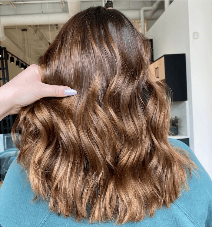 A person with long, wavy, auburn hair.