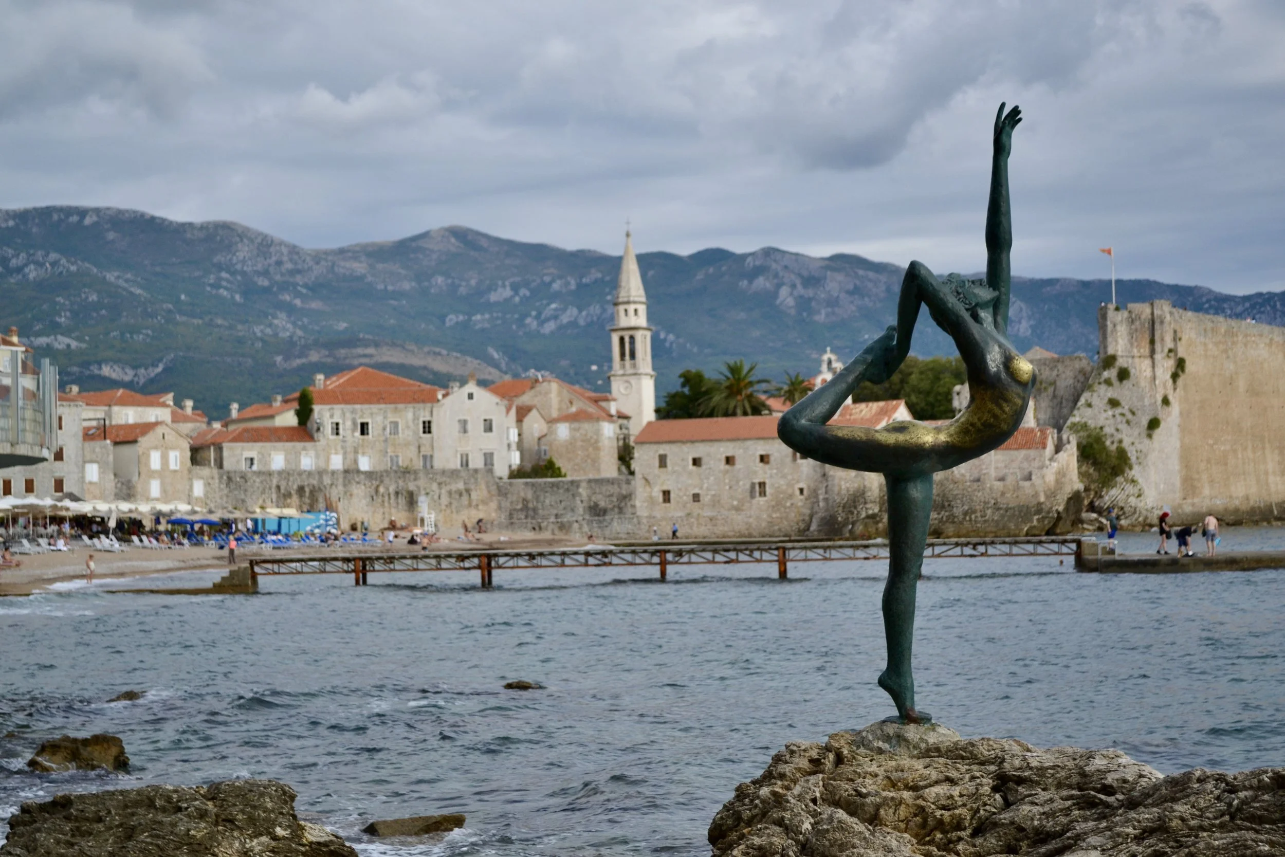 Dancing Girl statue looking on the Old Town in Budva, Montenegro