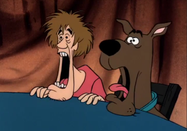  We're not sure what's going on under that table, but whatever it is it managed to devolve Shaggy into a caveman. 