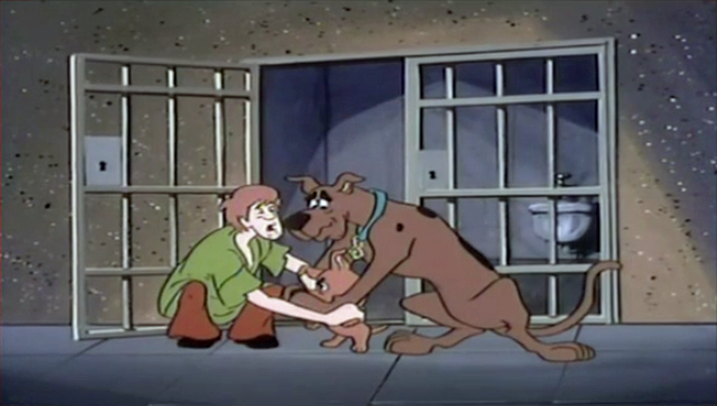  Shaggy and Scooby manage to restrain Scrappy before he tries to  SPLAT  individuals already paying their debts to society. 