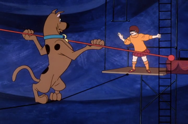  Velma shouts the opposite of encouragement to Scooby. 