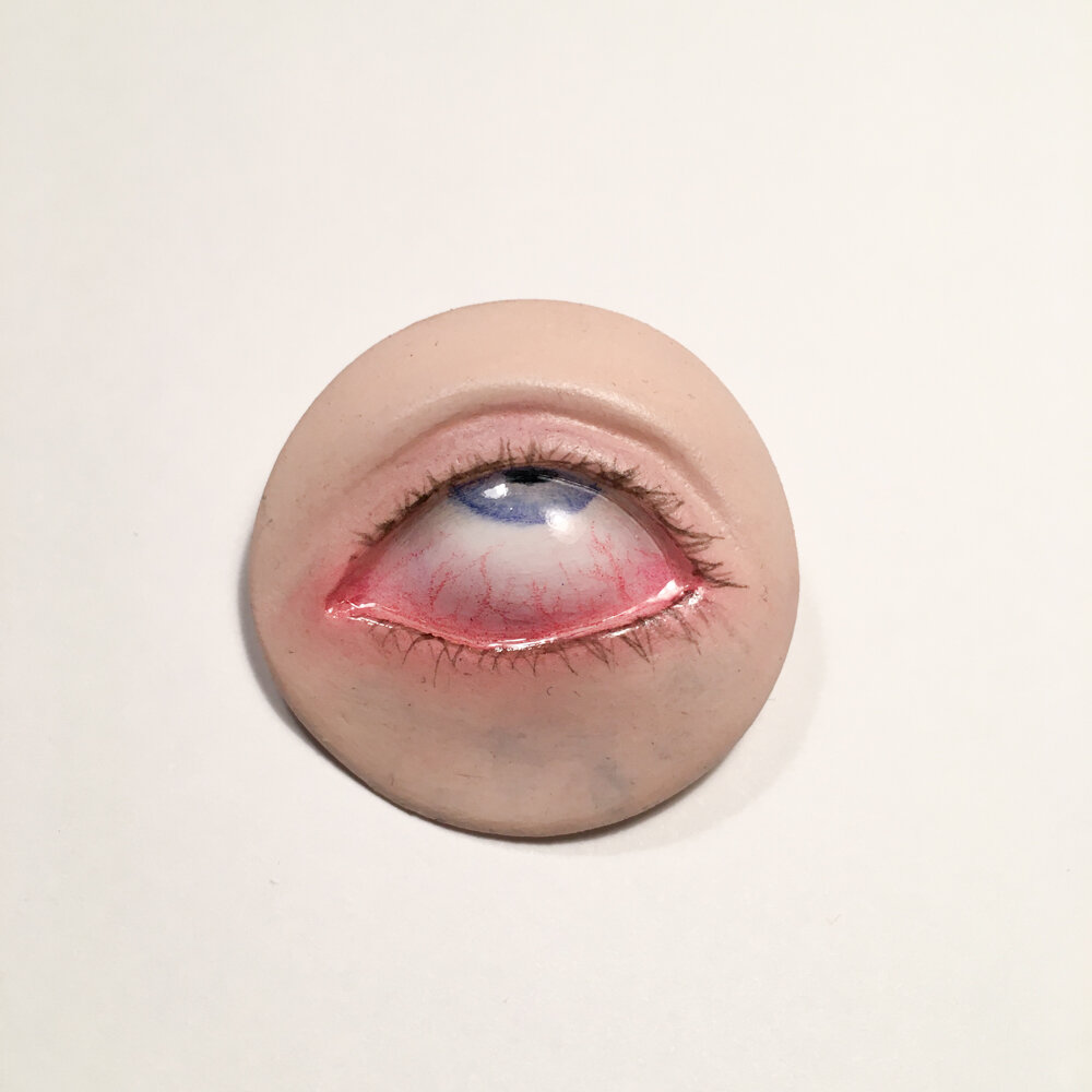  Ugh… Eyeball Pin, 2019. Air dry clay, acrylic, watercolor pencil, chalk pastel. 1.5” across. 