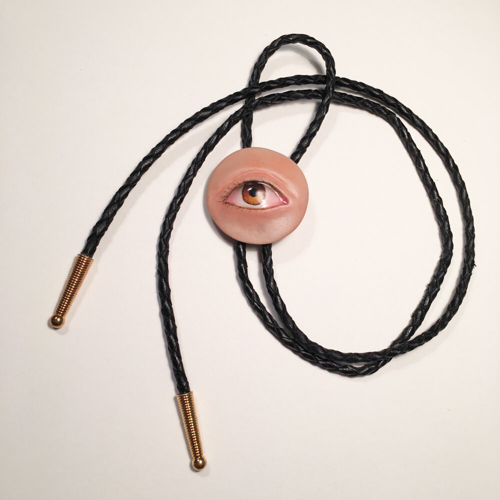  The Big Eye Bolo Tie. Air dry clay, acrylic, chalk pastel, watercolor pencil, leather, metal. 2019. 