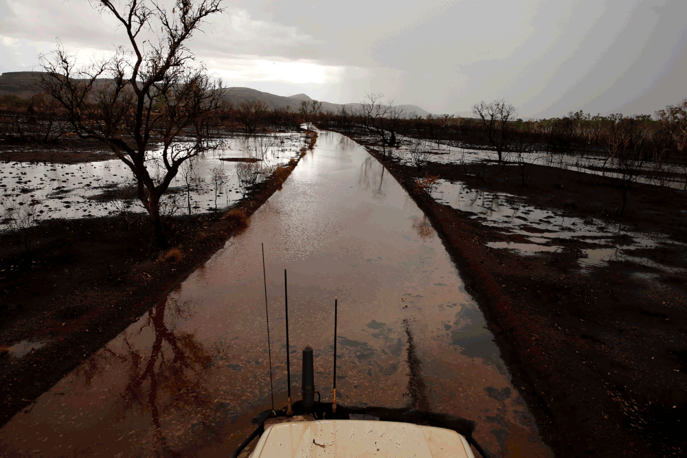  A flooded track after the passage of a torrential rain storm in 2013.&nbsp; A major feature of the Hamersley Range is the sheet flows that fun down off the range after storms.&nbsp; The gradient is so flat that the water runs very slowly and this sl